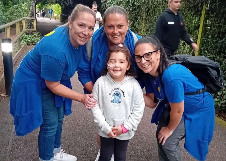 Lilyana with PASIC support workers at Alton Towers
