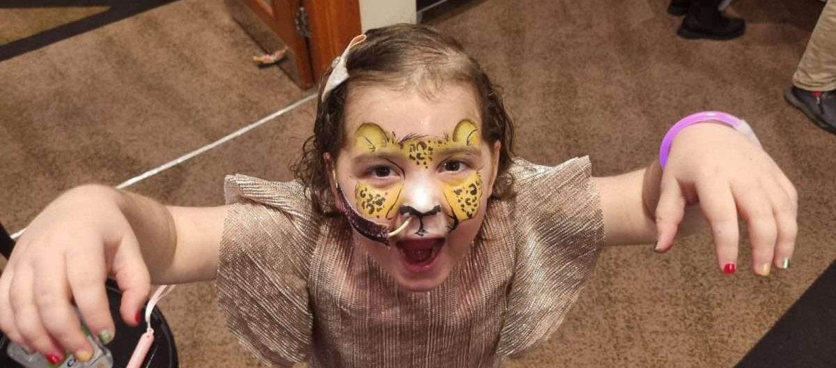 Lilyana with face painted at a PASIC party